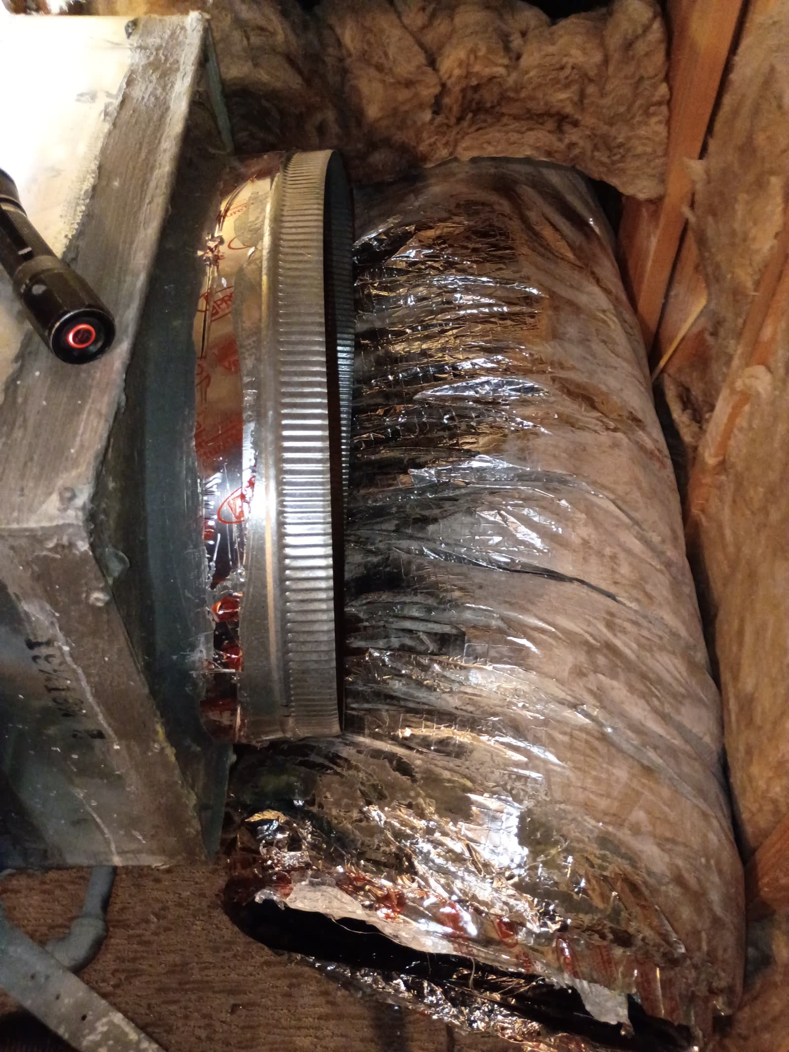 Residential air duct connection inspected in a Los Angeles attic